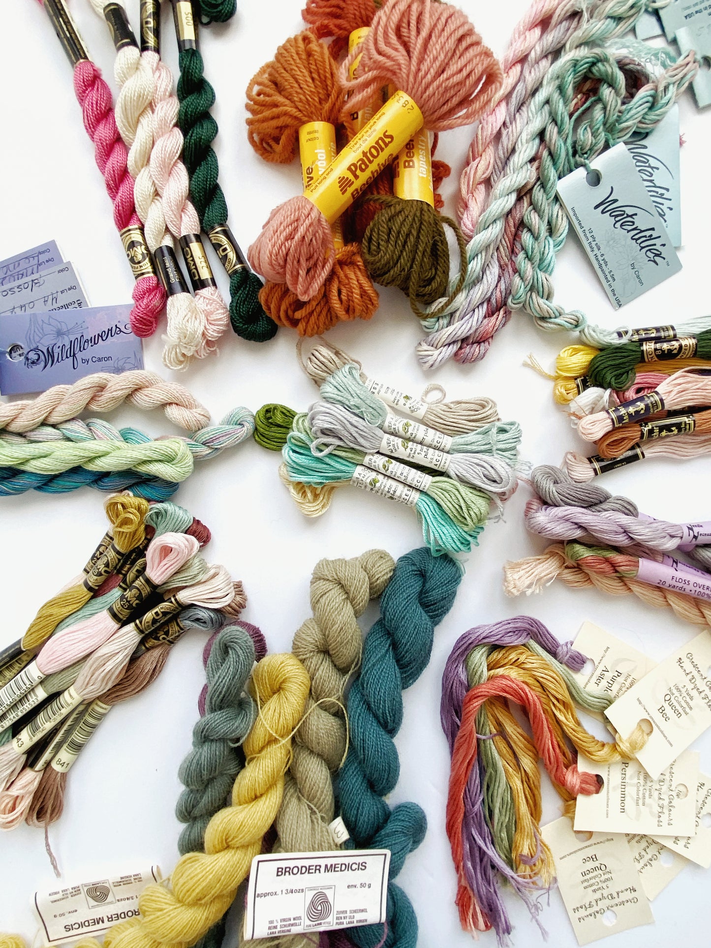Various embroidery threads from different brands arranged in an artful assortment for surprise bag examples.