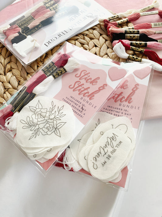Homebody Handmade's Valentine's Stick and Stitch Pack is pictured on woven trivet. A variety of DMC threads in complimentary colours are shown and there are a number of different designs featured in the package.