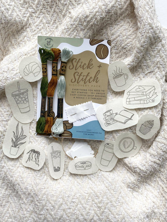 Packaging and assorted embroidery designs for a DIY craft kit, with visible thread and needles.