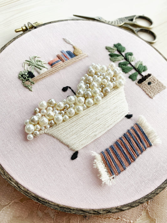 Embroidery hoop art featuring a bubble bath scene where the bubbles are pearl beads for hand embroidery inspiration.