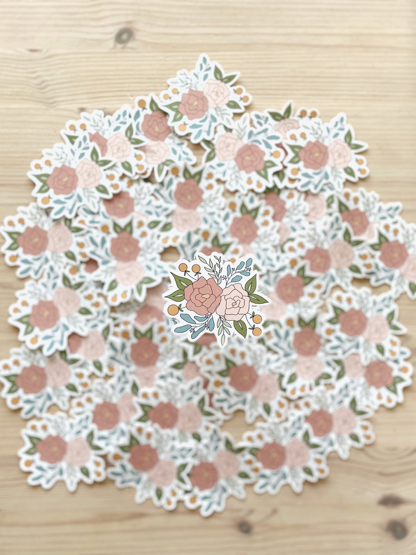 A crisp image of a sticker featuring a floral arrangement is contrasted with a blurred background of matching stickers.
