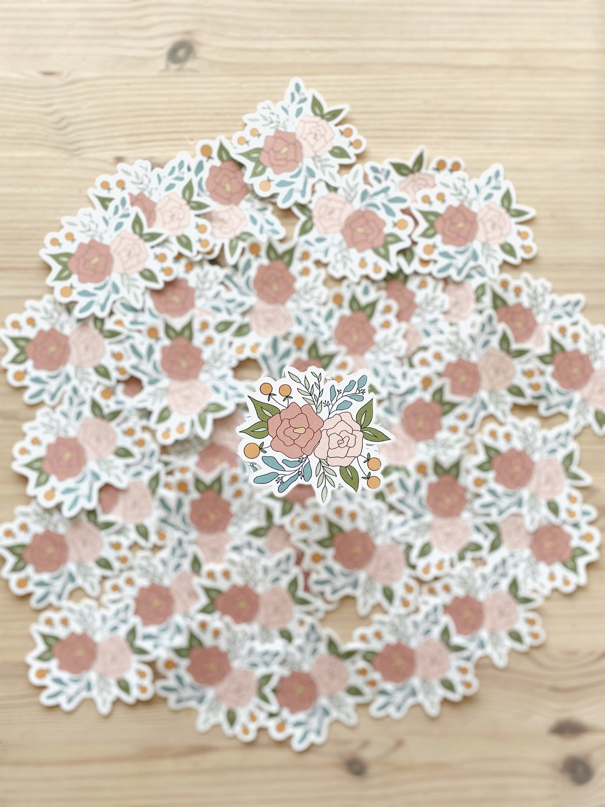 A crisp image of a sticker featuring a floral arrangement is contrasted with a blurred background of matching stickers.