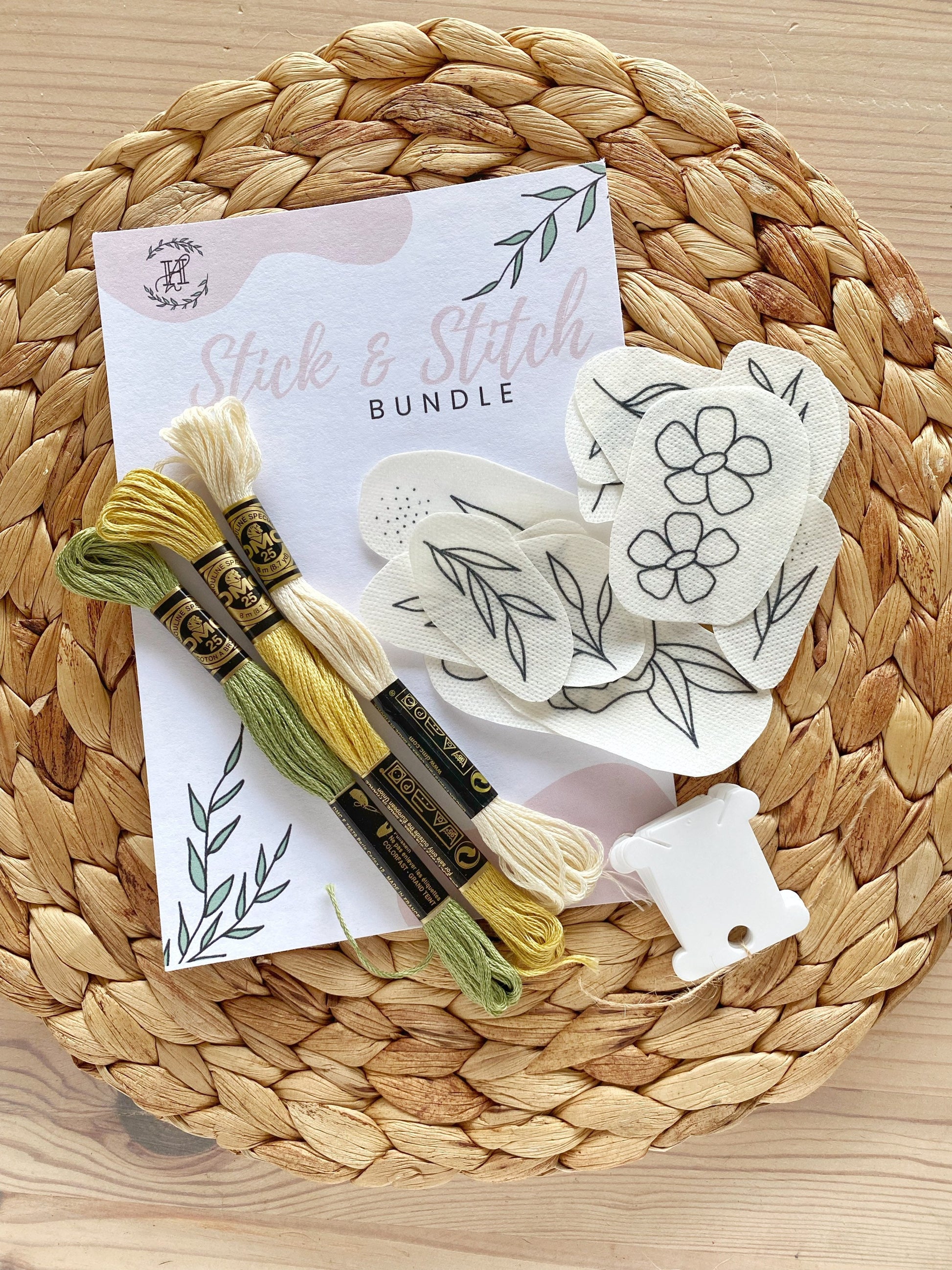 A Stick and Stitch embroidery kit including floral patterns, threads, and needle, perfect for learning embroidery and creating colorful designs.