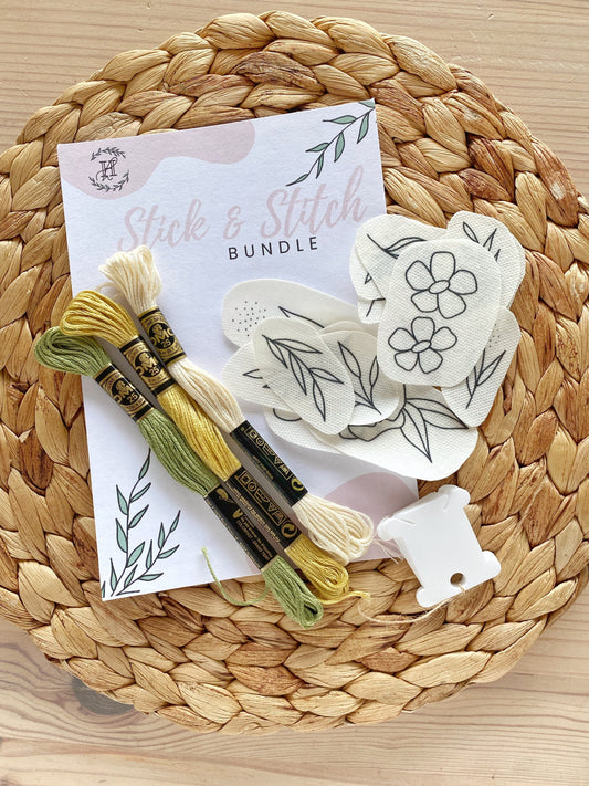 A Stick and Stitch embroidery kit including floral patterns, threads, and needle, perfect for learning embroidery and creating colorful designs.