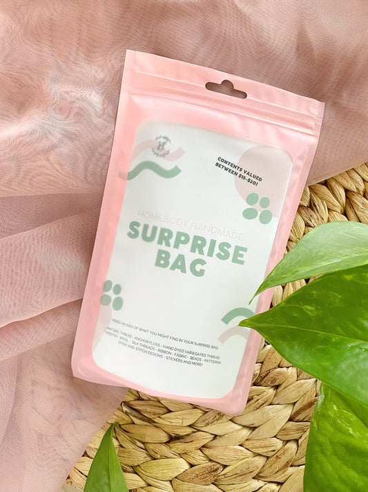 An embroidery surprise bag artfully displayed on a textured background.